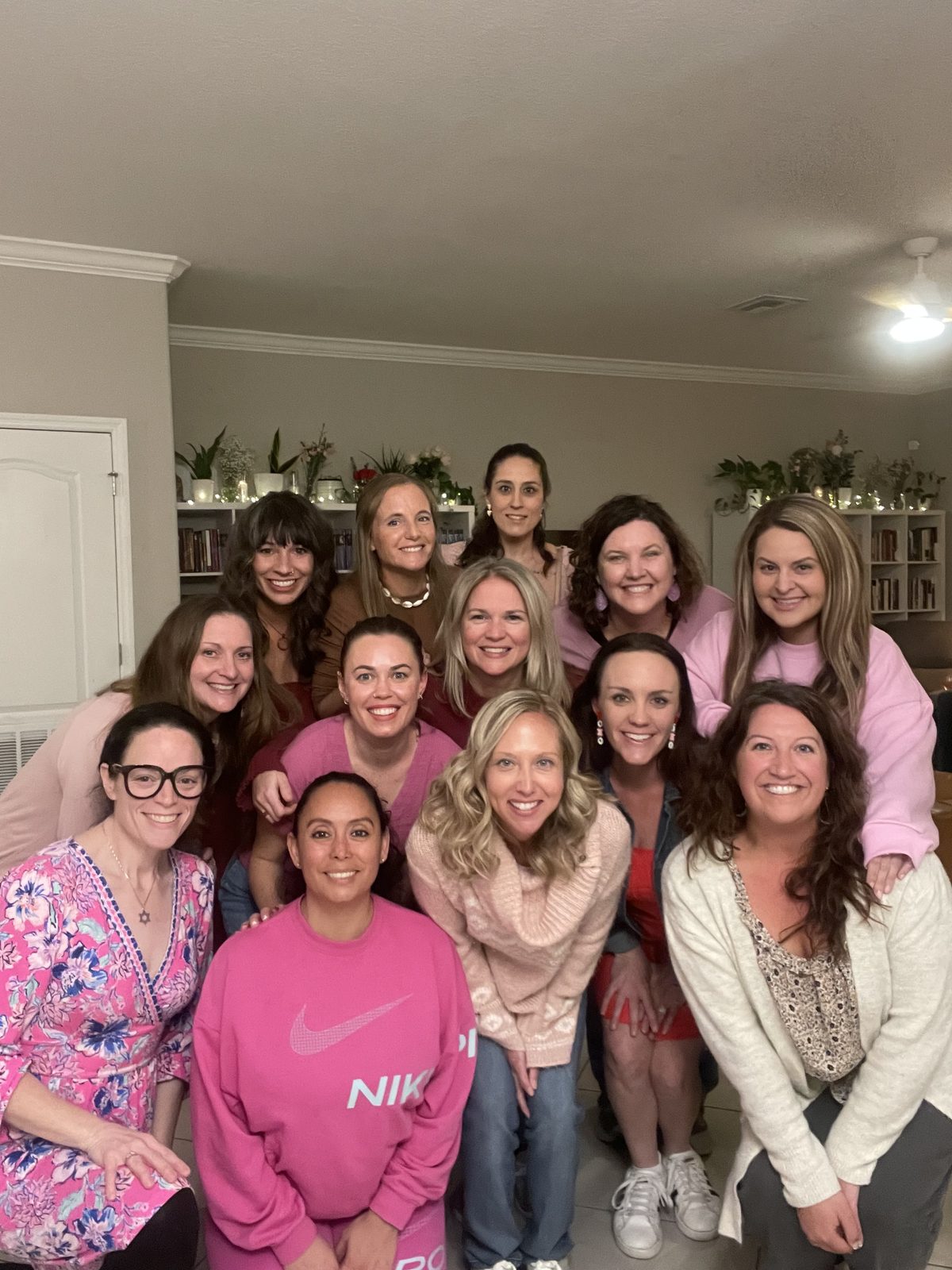 Crystal Joy and a book club group posing together at an evening reading-group get-together