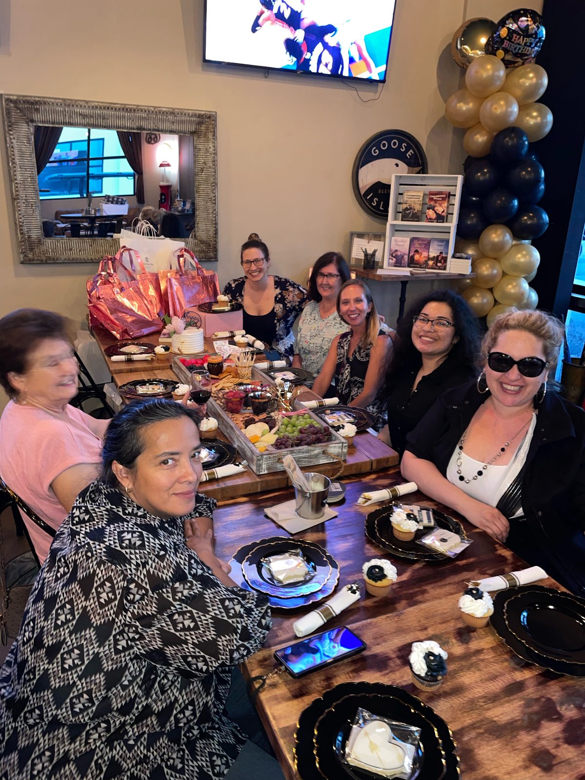 Crystal Joy joining a book club around the table at a restaurant celebration
