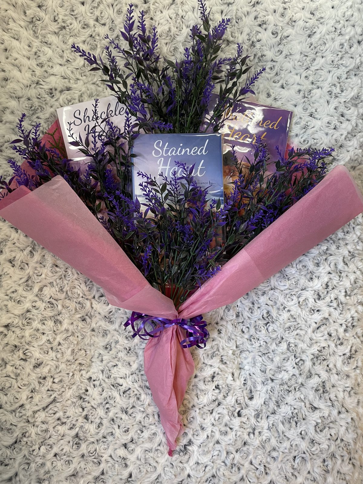 Crystal's seasonal signed-book gift package — a lavender bouquet tucked among her novels in rose tissue